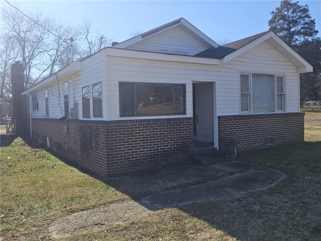 209 Burnett Ferry Road Southwest Rome, GA 30165 - Photo 1 of 1 a front view of a house with a yard