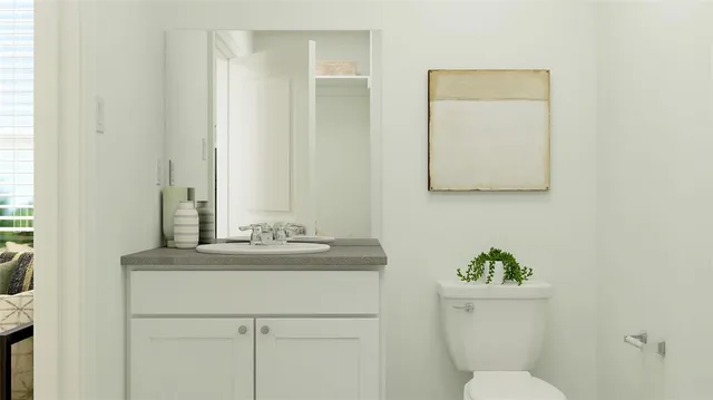 a bathroom with a toilet sink and mirror