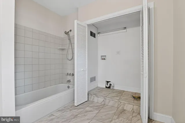 a bathroom with a bathtub and a shower