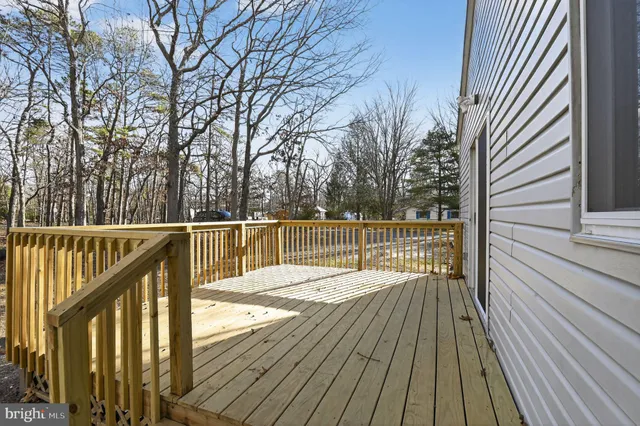a view of balcony with wooden floor and fence
