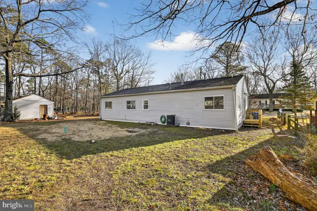a view of a house with a yard covered with snow in front of it
