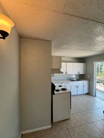 a kitchen with stainless steel appliances a sink stove and cabinets