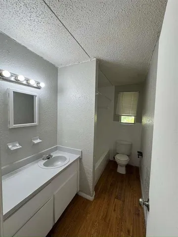 a bathroom with a sink mirror and toilet