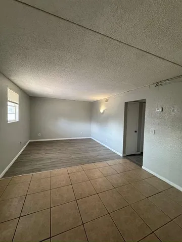 a view of a livingroom with a dishwasher and a window in a room