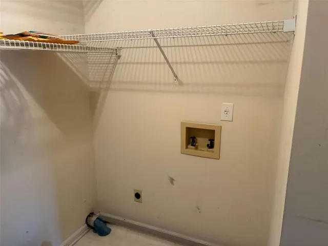 a view of a hallway with wooden shelves