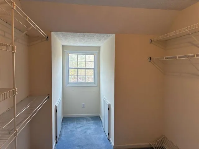 a view of a room that has a fan and a window