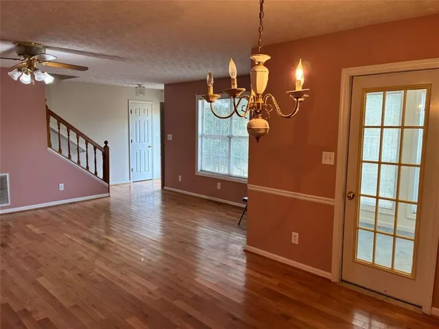 a kitchen with stainless steel appliances granite countertop a refrigerator a stove top oven a sink and dishwasher