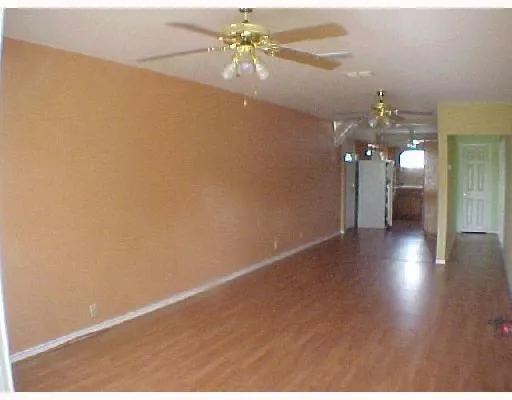 a view of a livingroom with a chandelier fan