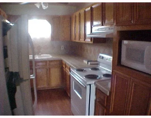 a kitchen that has a sink and a stove