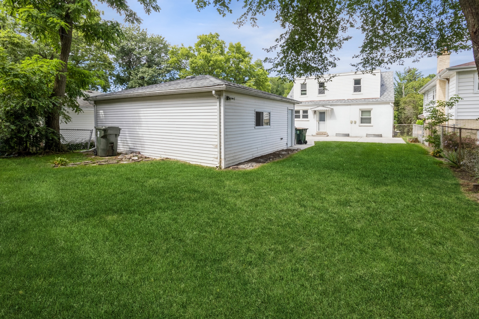 1621 West Talcott Road Park Ridge, IL 60068 - Photo 24 of 26 a view of a white house with a big yard plants and large trees