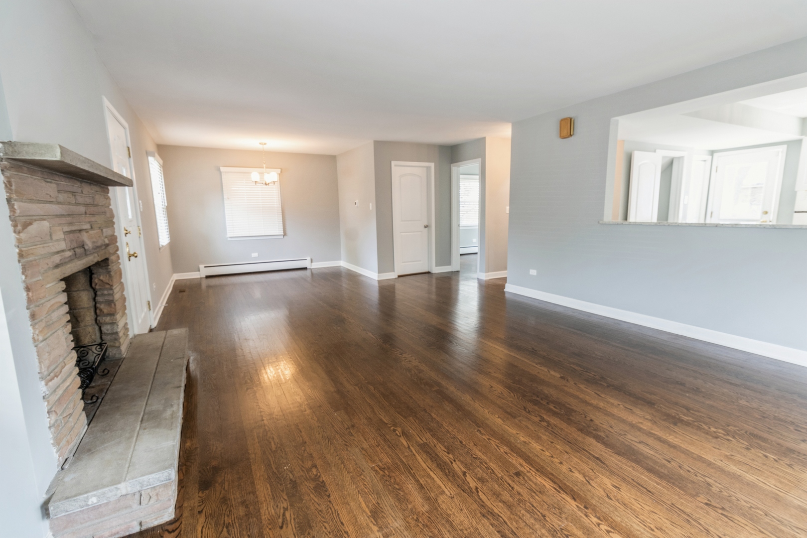 1621 West Talcott Road Park Ridge, IL 60068 - Photo 6 of 26 an empty room with wooden floor and a fireplace