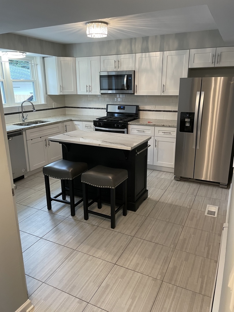 1621 West Talcott Road Park Ridge, IL 60068 - Photo 7 of 26 a kitchen with a sink cabinets and stainless steel appliances