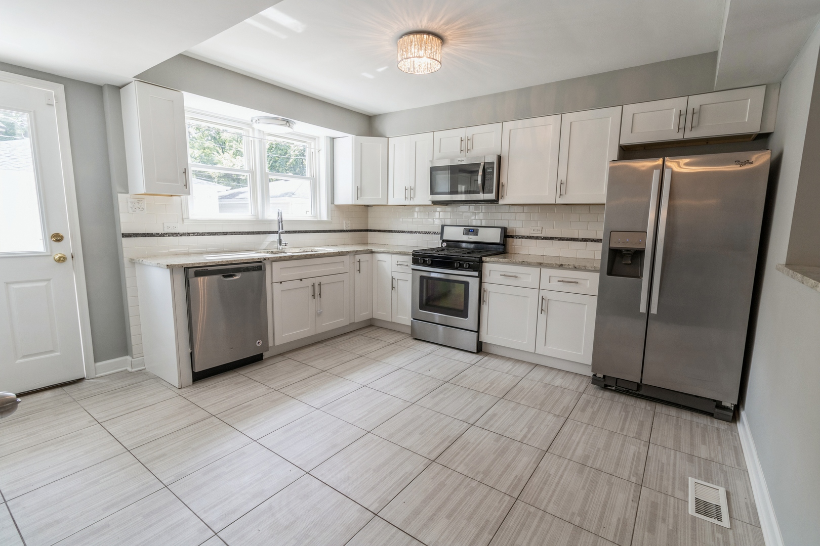 1621 West Talcott Road Park Ridge, IL 60068 - Photo 8 of 26 a kitchen with stainless steel appliances granite countertop a stove a sink and a refrigerator