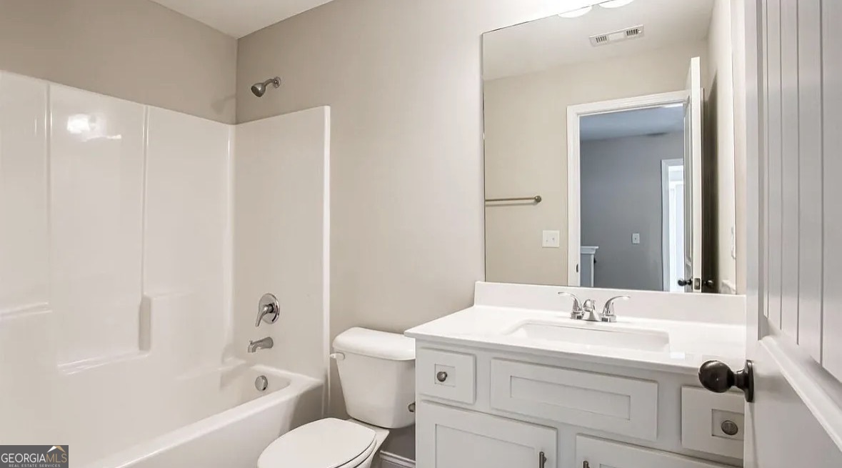 244 Sophie Circle Locust Grove, GA 30248 - Photo 11 of 11 a bathroom with a sink toilet and shower