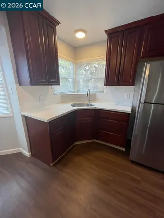 a kitchen with wood cabinets sink and stainless steel appliances