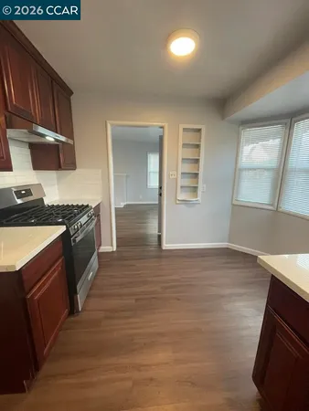 a kitchen with granite countertop a stove and a sink