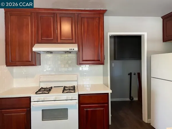 a kitchen with a stove and a refrigerator
