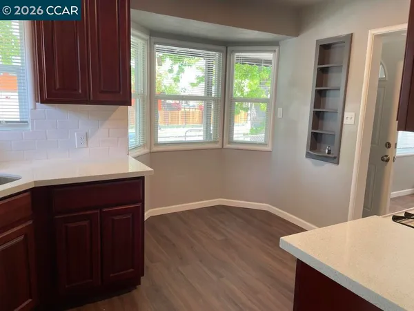a kitchen with a wooden floor and a window