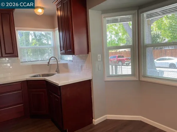 a kitchen with a sink window and cabinets