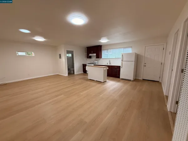 a kitchen with stainless steel appliances a sink a stove a refrigerator and cabinets