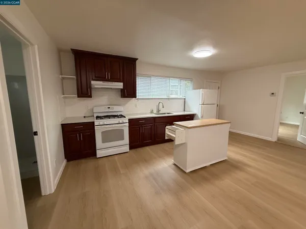 a kitchen with stainless steel appliances granite countertop a stove a sink dishwasher and a refrigerator