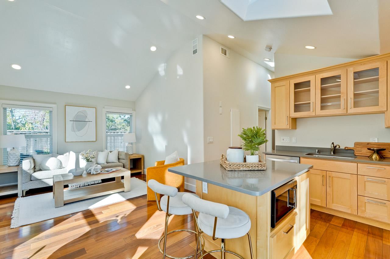 a living room with kitchen island furniture and a kitchen view