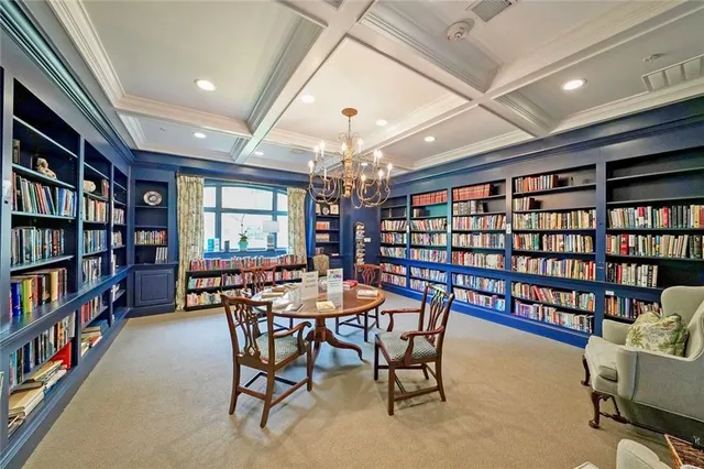 a view of a livingroom with furniture and a bookshelf