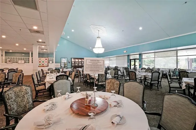 a large kitchen with a table and chairs