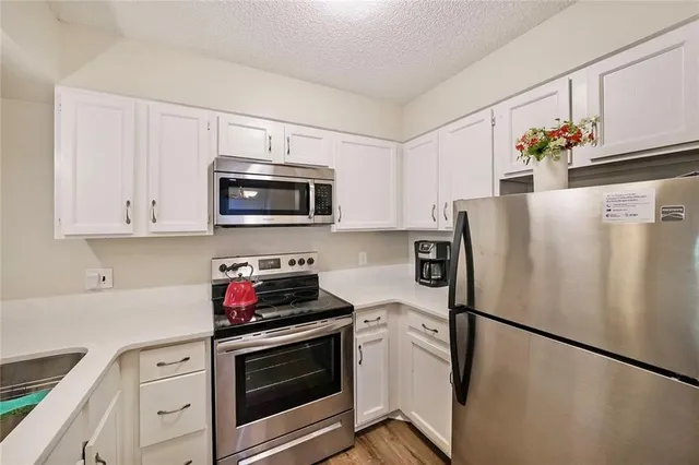 a kitchen with stainless steel appliances a refrigerator stove and microwave