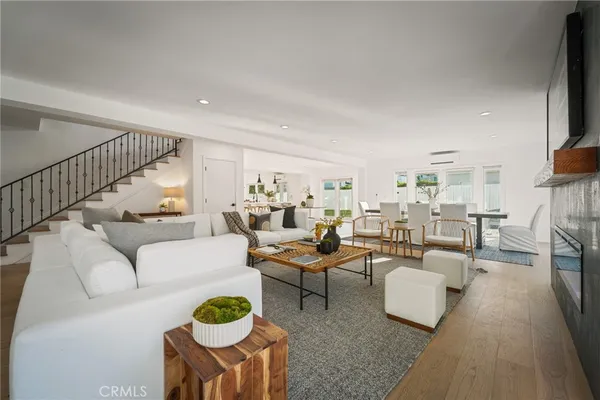 a living room with fireplace furniture and a rug
