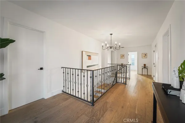 a view of a bedroom with wooden floor