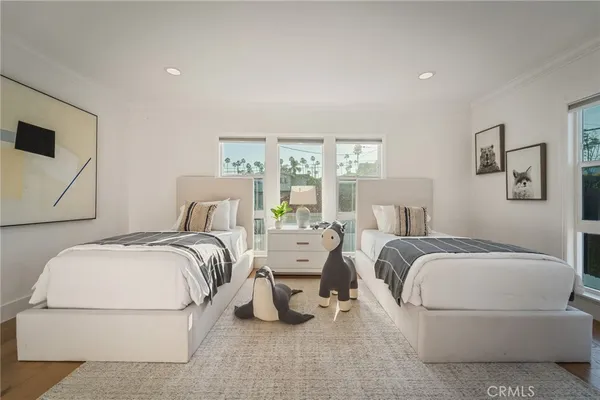 a bedroom with bed and white cabinets