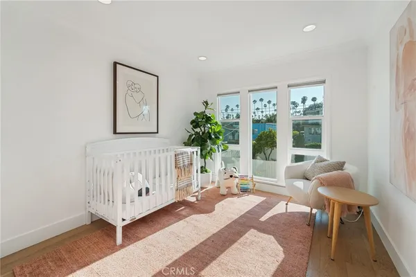 a bedroom with furniture and a large window