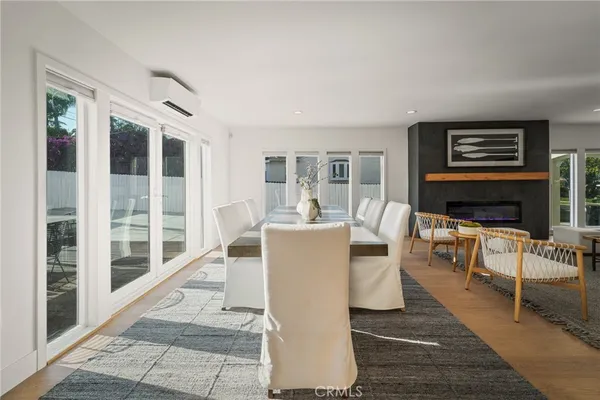 a living room with furniture a large window and a fireplace