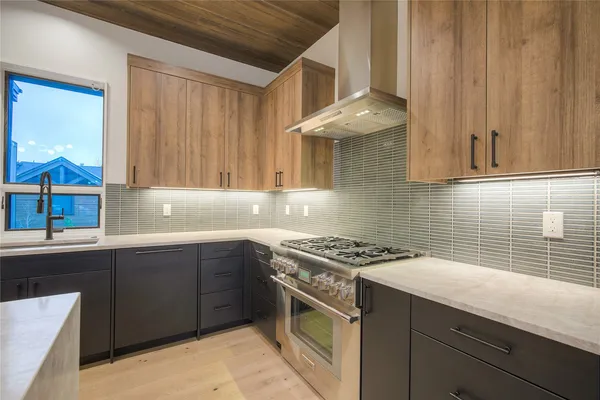 a kitchen with a sink stove and cabinets