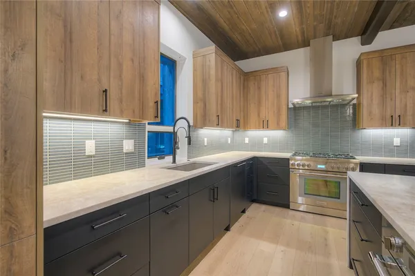 a kitchen with stainless steel appliances granite countertop a sink stove and cabinets