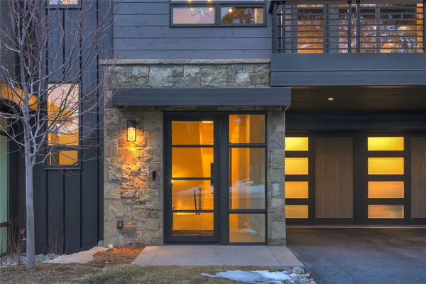 a view of entrance front of house with wooden fence