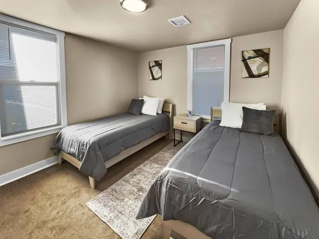 a bedroom with a bed and window