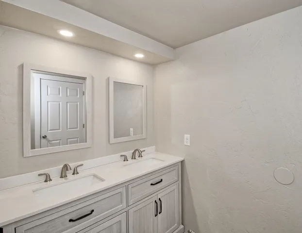 a bathroom with a sink vanity and a mirror
