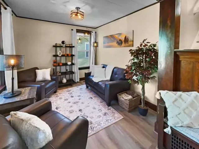 a living room with furniture and a potted plant