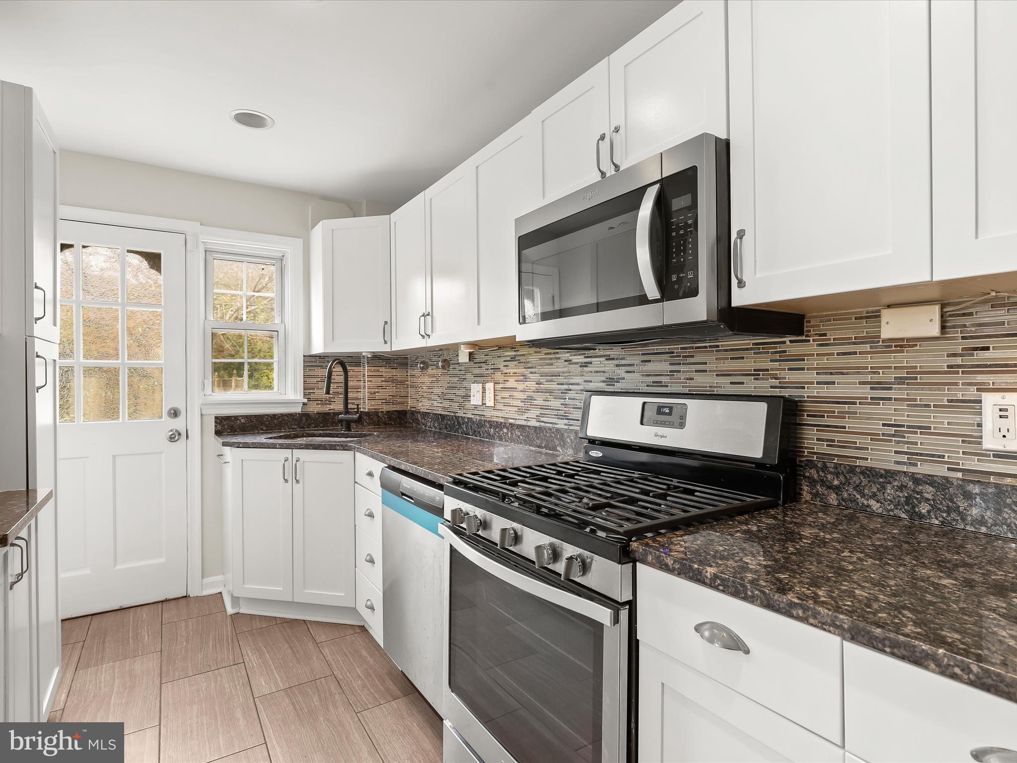 8328 Wyton Road Towson, MD 21286 - Photo 11 of 36 a kitchen with stainless steel appliances granite countertop a stove microwave and sink