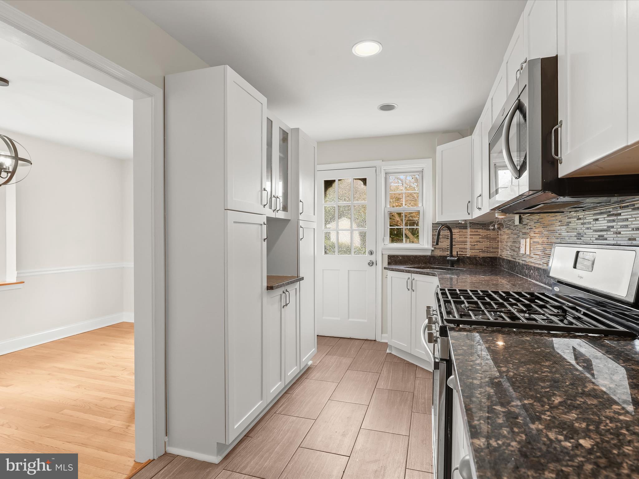 8328 Wyton Road Towson, MD 21286 - Photo 12 of 36 a kitchen with cabinets and a stainless steel refrigerator