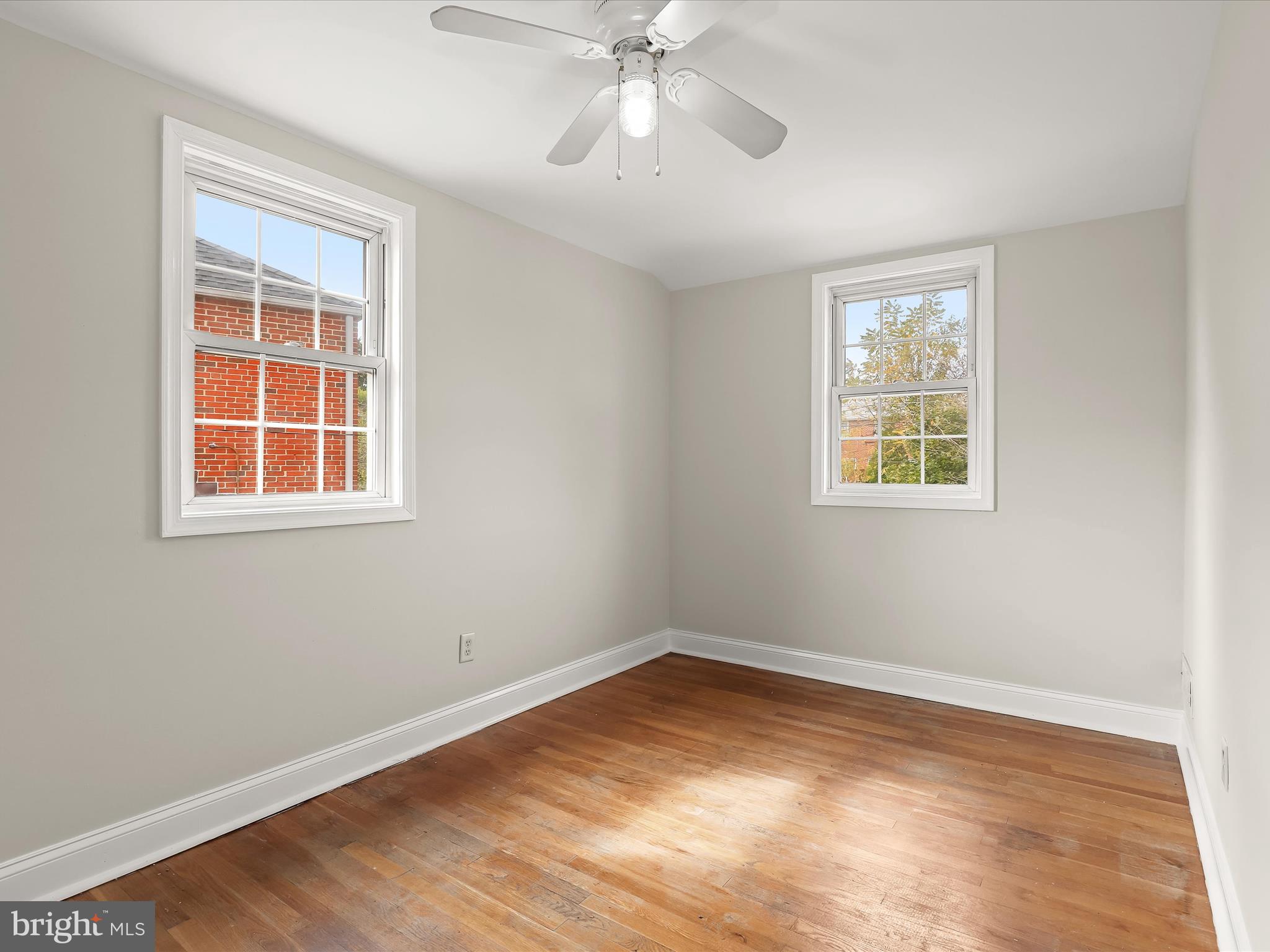 8328 Wyton Road Towson, MD 21286 - Photo 17 of 36 a view of empty room with wooden floor and fan