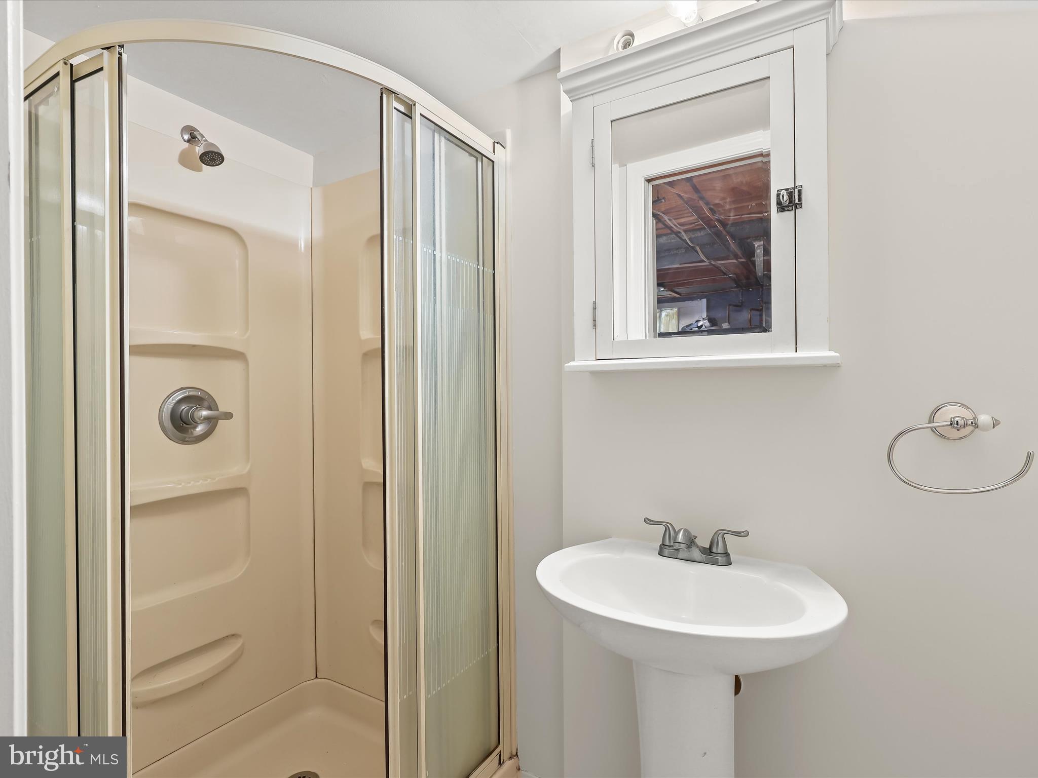 8328 Wyton Road Towson, MD 21286 - Photo 25 of 36 a bathroom with a sink mirror and shower