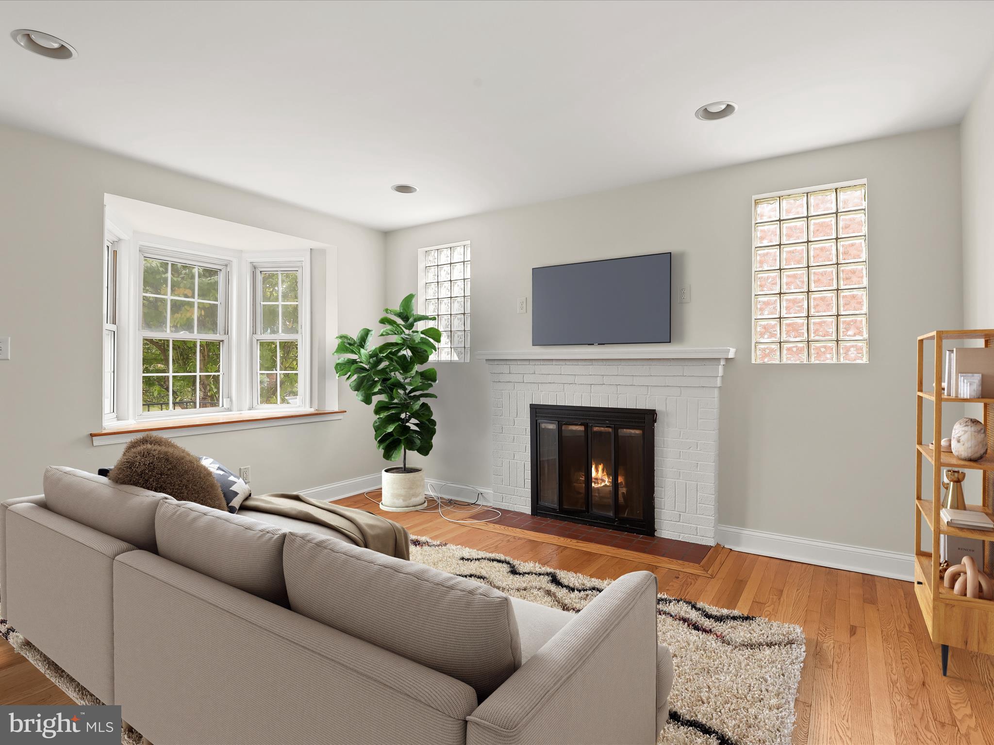 8328 Wyton Road Towson, MD 21286 - Photo 4 of 36 a living room with furniture window and a fireplace