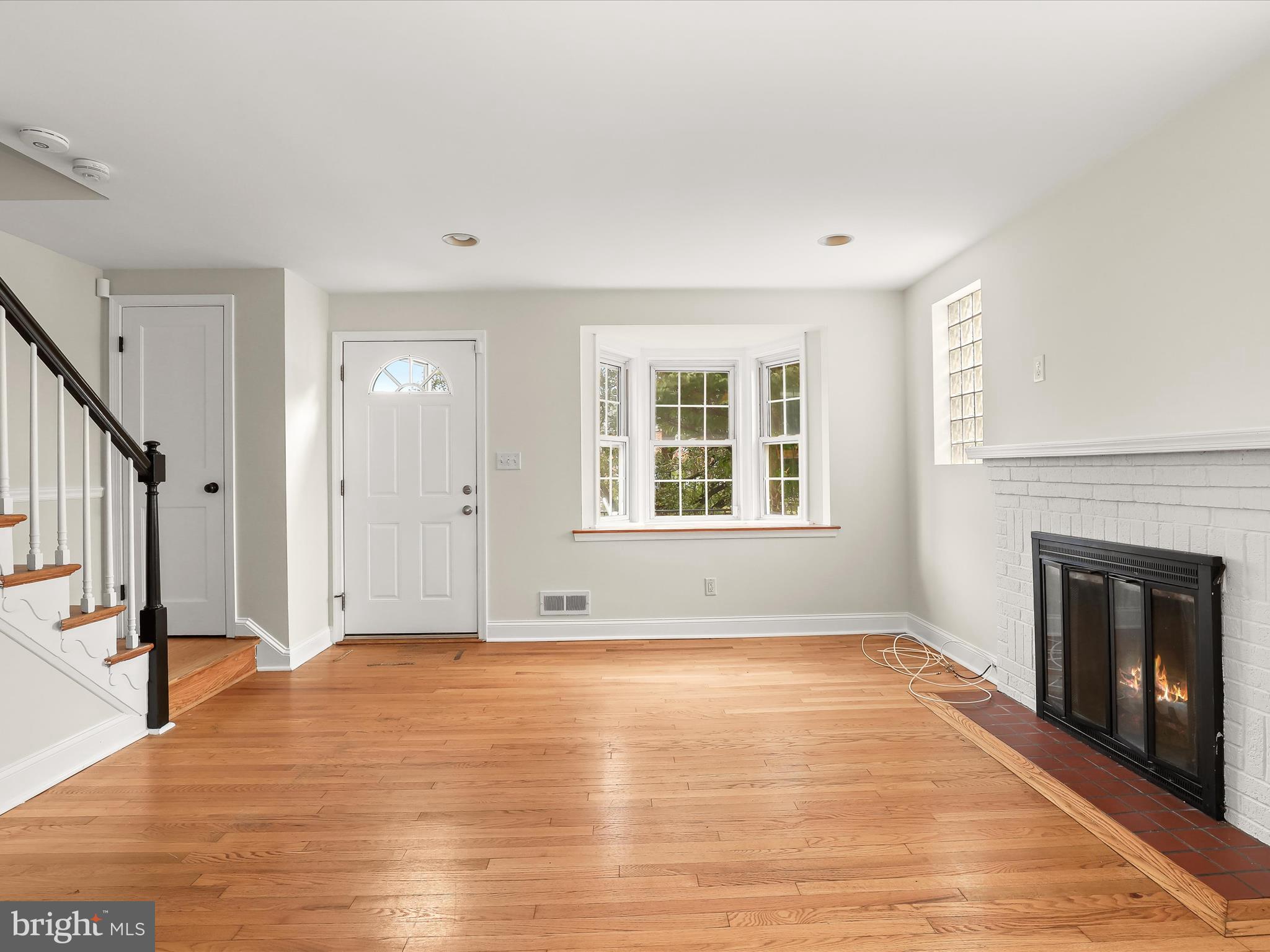 8328 Wyton Road Towson, MD 21286 - Photo 5 of 36 a view of empty room with wooden floor and fireplace