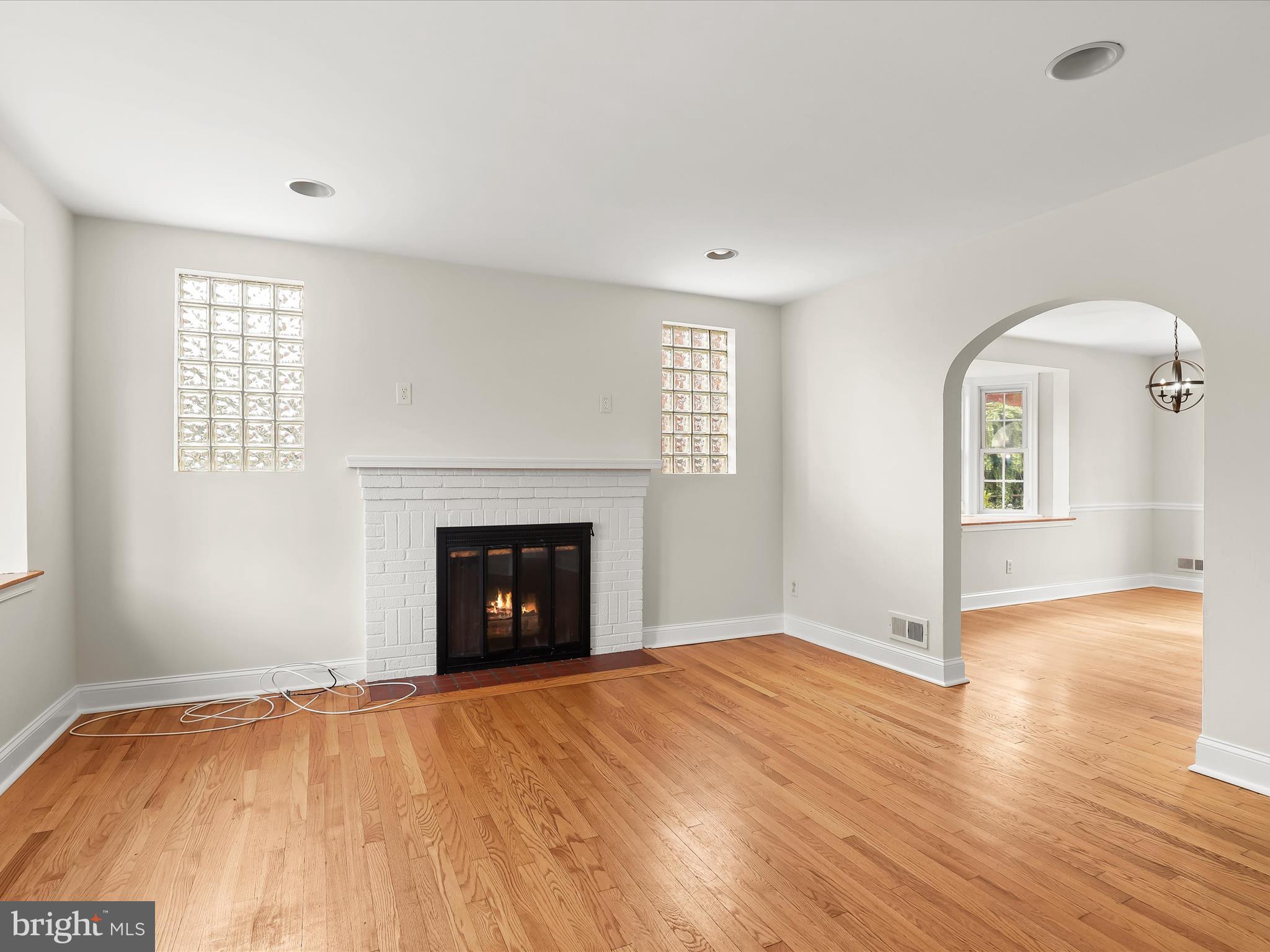 8328 Wyton Road Towson, MD 21286 - Photo 6 of 36 an empty room with windows and fireplace