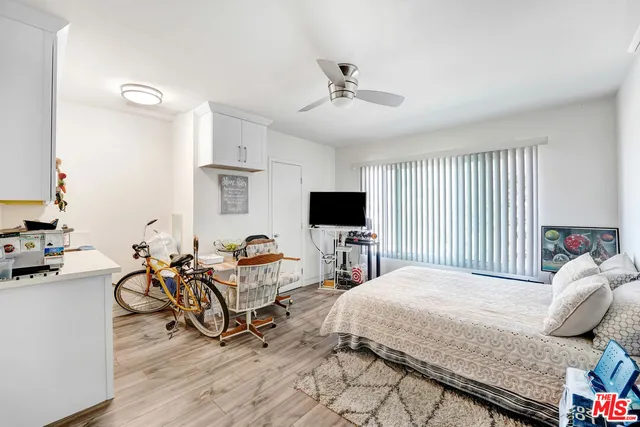 a bedroom with furniture and a flat screen tv