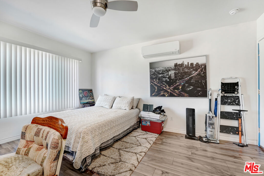 1740 Hauser Boulevard, Unit 8 Los Angeles, CA 90019 - Photo 4 of 10 a bedroom with a bed and a view of kitchen