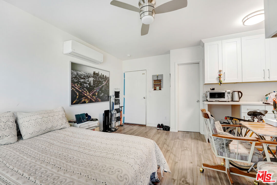 1740 Hauser Boulevard, Unit 8 Los Angeles, CA 90019 - Photo 5 of 10 a bedroom with a bed and a cabinets